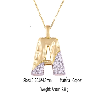 Detail of two-tone brass letter A pendant with cubic zirconia and exact dimensions