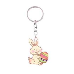 Cartoon rabbit keychain holding Easter egg with colorful enamel finish on white background