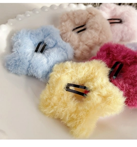 Close-up of colorful plush star hair clips in soft faux fur texture with metal BB grips
