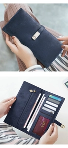 Detail view of deep blue wallet showing interior card slots and golden metal clasp