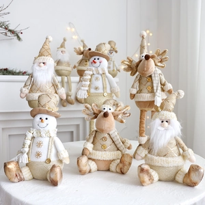 Detail of Christmas plush figurines in gold and white with festive sparkling accents