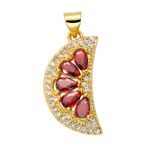 Detail of cross heart pendant with gold plating, red gemstones, and white zircon accents