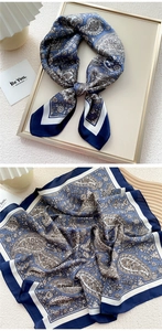 Detail of blue and white paisley silk scarf showing elegant texture and artistic patterns