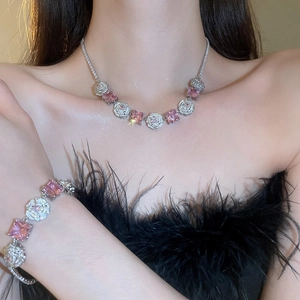 Close-up of model wearing silver flower jewelry set with pink stones and white zircons