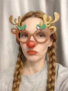Close-up of reindeer Christmas glasses with gold antlers and red nose for party fun