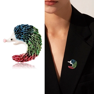 Detail of colorful enamel hedgehog brooch with vibrant blue red and green gradient finish