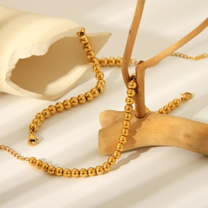 Minimalist 18K gold stainless steel bead bracelet for women featuring an adjustable chain