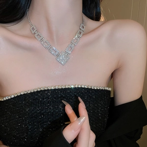 Close-up of luxury silver geometric square necklace with shimmering pave rhinestones