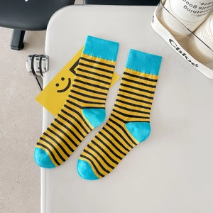 Vibrant striped cotton crew socks for men and women featuring yellow, black, and blue accents
