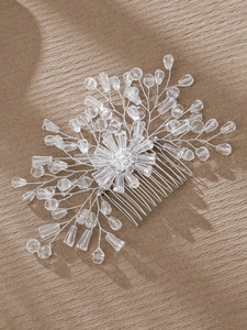 Macro detail of bridal hair comb with silver wire, crystal beads and pearls