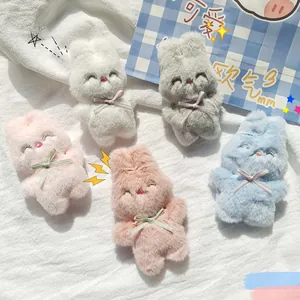 Détail de cinq pendentifs lapins en peluche colorés avec des nœuds papillon mignons