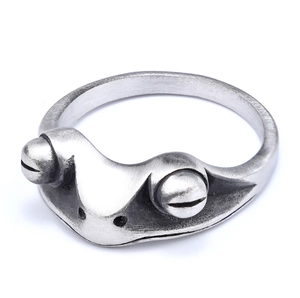 Detailed close-up of a vintage silver frog ring with intricate metallic textures