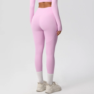 Close-up of high-waisted yoga leggings with peach hip lifting seams in soft pink