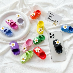 Colorful flower charm phone grip stand inspired by classic clog shoe design and aesthetics