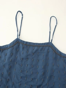 Detail of blue chiffon camisole featuring delicate beadwork and thin shoulder straps