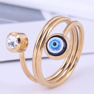 Macro shot of gold spiral ring with sparkling zircon and protective evil eye detail