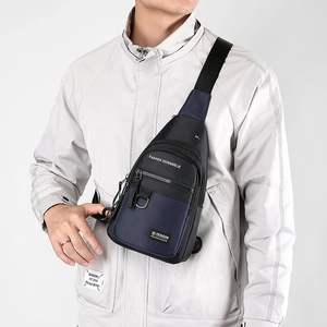 Water-resistant men's crossbody chest bag in black and navy nylon shown on a model