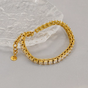 Close-up of gold stainless steel tennis bracelet with square-cut clear cubic zirconia