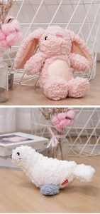Detailed view of pink rabbit and white seal plush pet toys with soft fleece texture