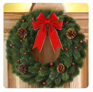 Detailed Christmas wreath with pine cones, red berries and a large festive velvet bow