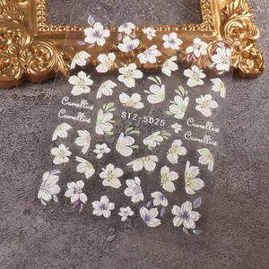 Macro detail of 5D embossed nail stickers with white camellias and green leaf patterns