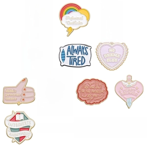 Set of 13 pastel enamel pins with rainbow motifs and humorous quotes for clothing