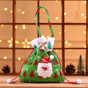 Green Christmas gift bag with plush Santa Claus and festive red snowflake patterns