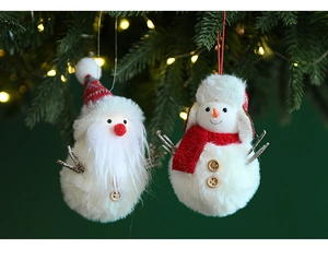 Detail of plush Santa and Snowman ornaments hanging on a festive Christmas tree