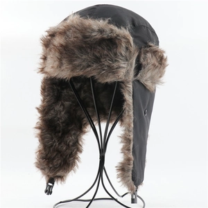 Detailed view of the brown faux fur lining and buckle strap on a black trapper hat