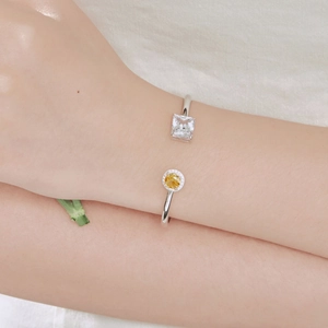 Close-up of S925 sterling silver bangle with square clear and round yellow zircon stones