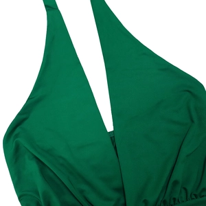 Detail of green V-neck halter dress showing gathered fabric and elastic texture