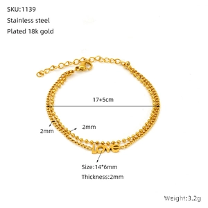 Detail showing 18K gold plated stainless steel double layer chain bracelet with Love charm