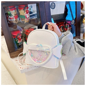 Detail of white glitter mini backpack with heart sequin window and wing decorations