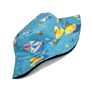 Detail of light blue bucket hat featuring yellow duck prints and reinforced brim stitching