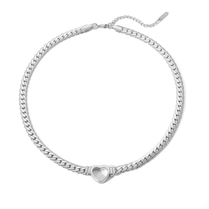 Detail of silver heart pendant and flat Cuban link necklace with lobster clasp closure