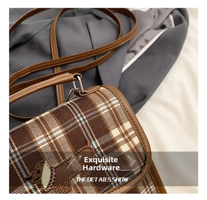 Detail of high-quality metallic hardware and stitching on the vintage checkered bag
