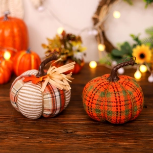 Harvest festival decor fabric pumpkins with plaid and stripe patterns on a desktop