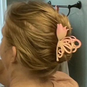Detail of 11cm pink gradient tulip hair claw clip worn in an elegant updo hairstyle