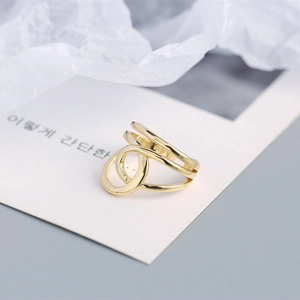 Macro shot of 925 sterling silver multilayer twisted open ring with 18K gold finish