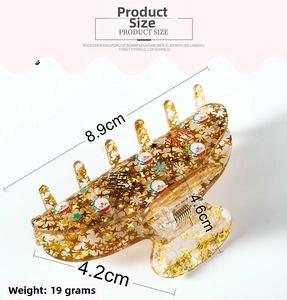 Detail view showing 8.9cm Santa Claus acrylic hair claw clip with festive gold glitter
