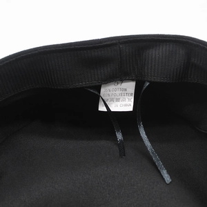 Detail view of cotton blend lining and size label inside the black flat top cap
