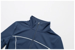 Detail of dark blue yoga jacket with white contrast stitching and a stand collar zip