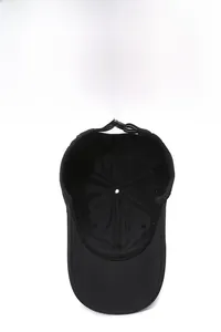 Detailed interior of black quick-dry baseball cap showing seams and breathable eyelets