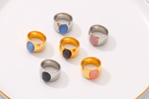 Nahaufnahme von breiten ovalen Katzenaugen-Ringen in Gold und Silber aus Edelstahl