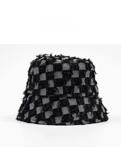 Side view of checkerboard bucket hat with distressed frayed edges and thick denim fabric