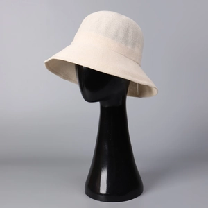 Detail view of beige woven sun hat texture on a display stand showing lightweight material
