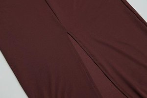 Close-up of slit design and double stitching on a deep red knit summer dress