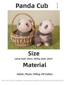 Detail of plush panda cubs in 20cm and 30cm sizes inside a woven basket on a green rug