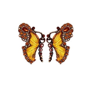 Vintage bronze butterfly necklace pendant with amber rhinestones on a white background