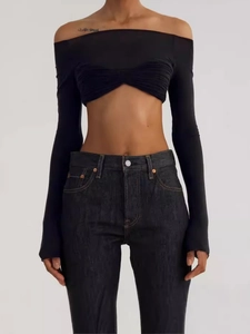 Sexy black off-shoulder long sleeve knit crop top paired with dark high-waist jeans